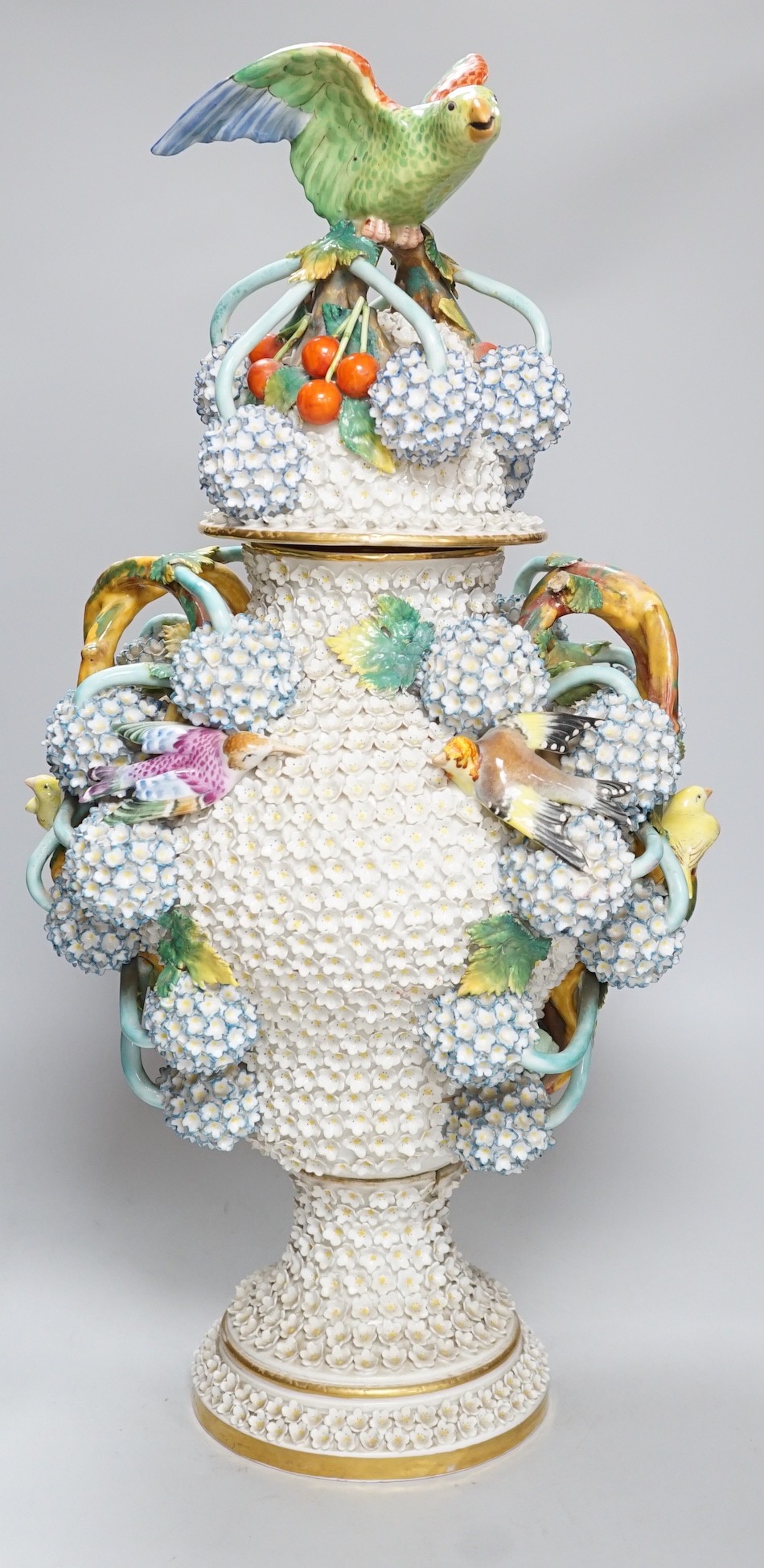 A large 19th century Jacob Petit floral encrusted two handled vase and cover, decorated with birds and flowers, 64cms high